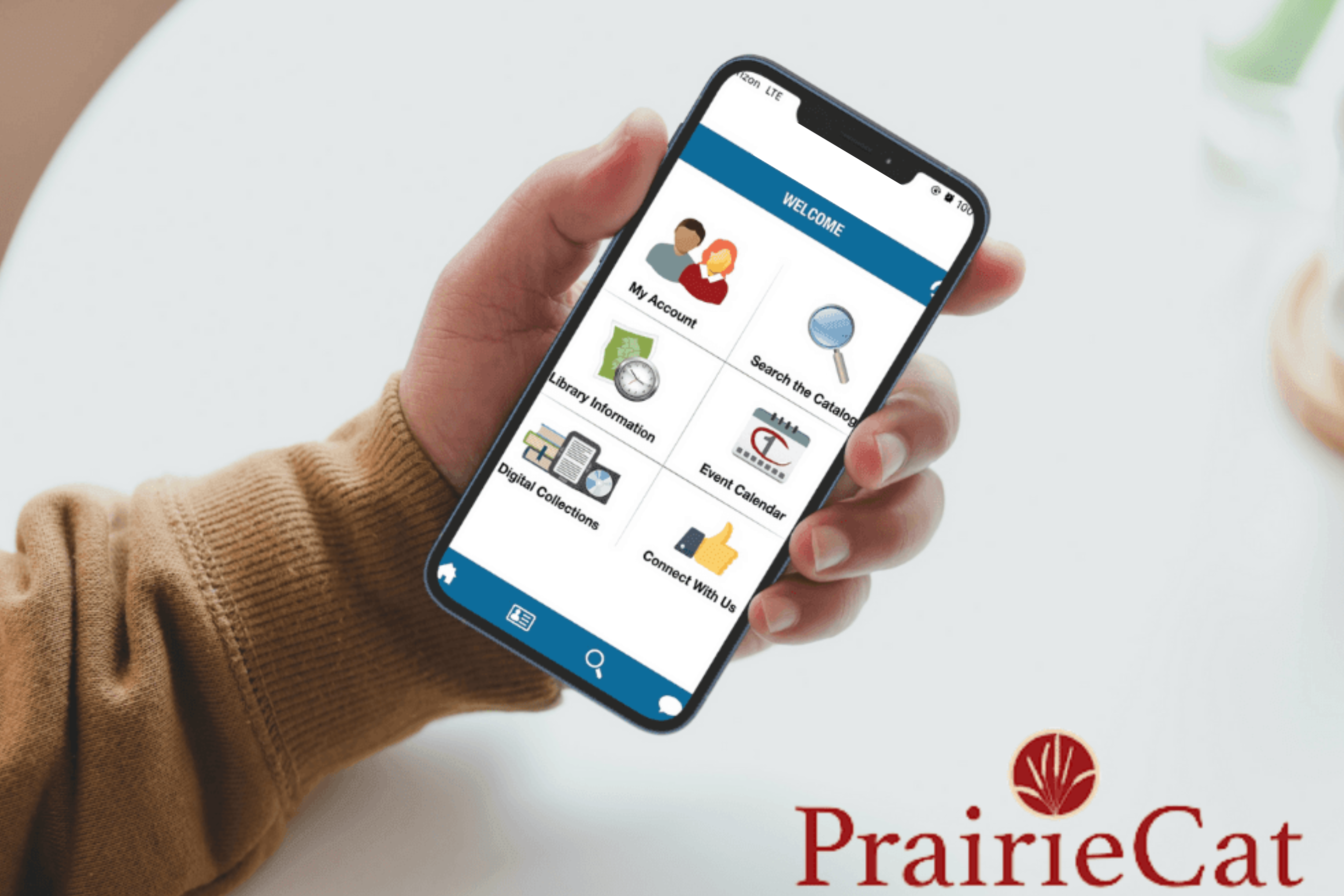 Person holding mobile phone with PrairieCat app on the screen