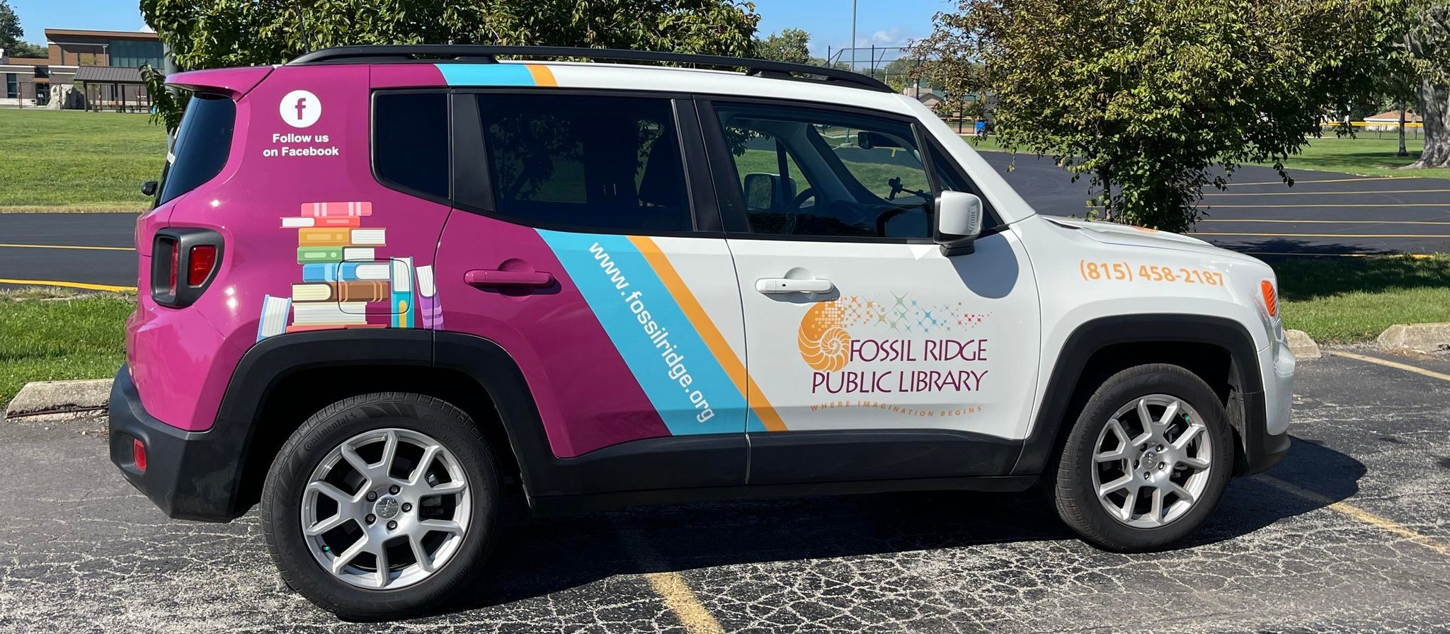 Mid-size SUV with branded Fossil Ridge Public Library wrap